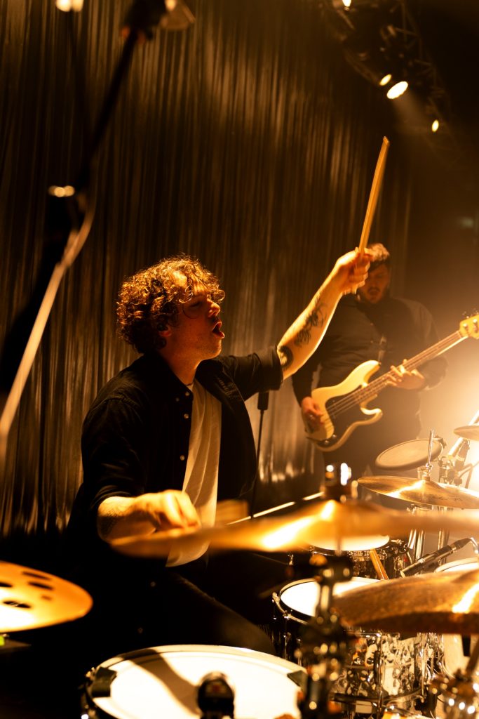 Gareth Grover on stage at a Frank Carter & The Rattlesnakes indoor gig